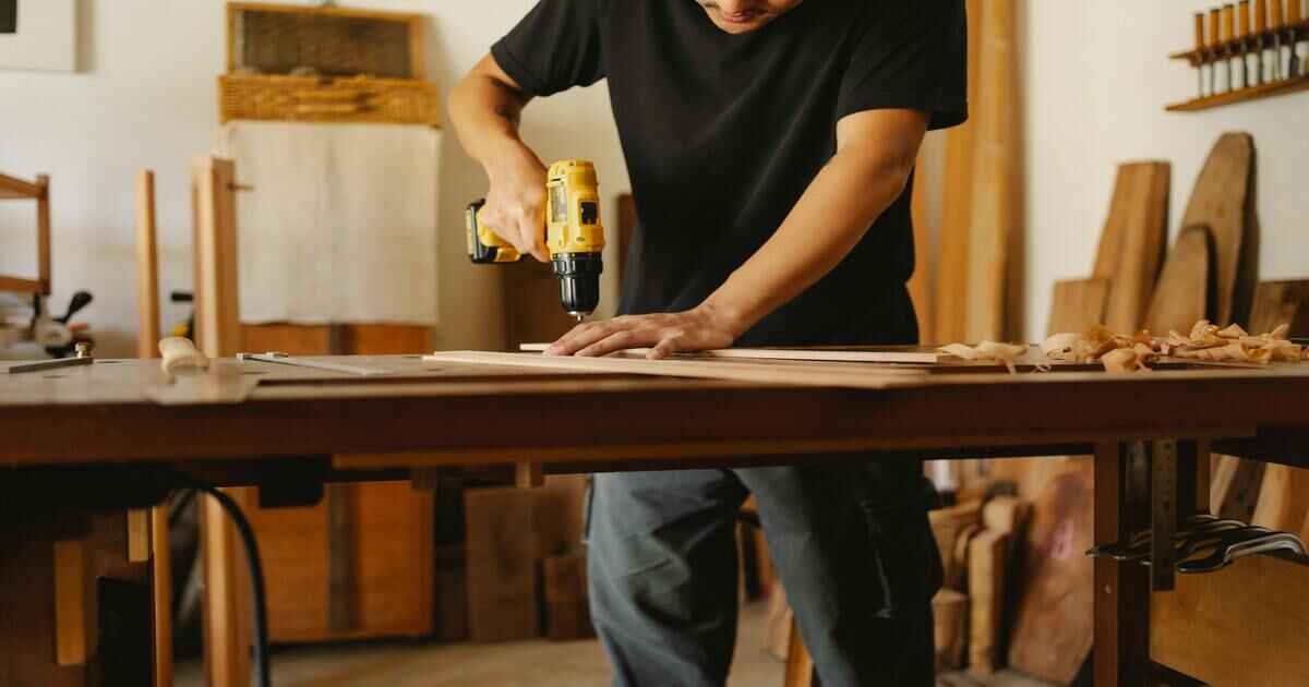 A man working on "4 feet Workbenches"